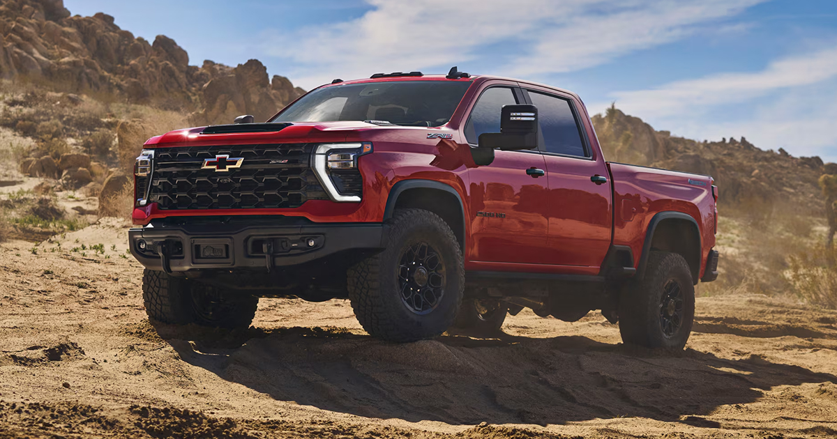 Red Chevrolet Silverado ZR2 pickup truck positioned on rocky desert terrain