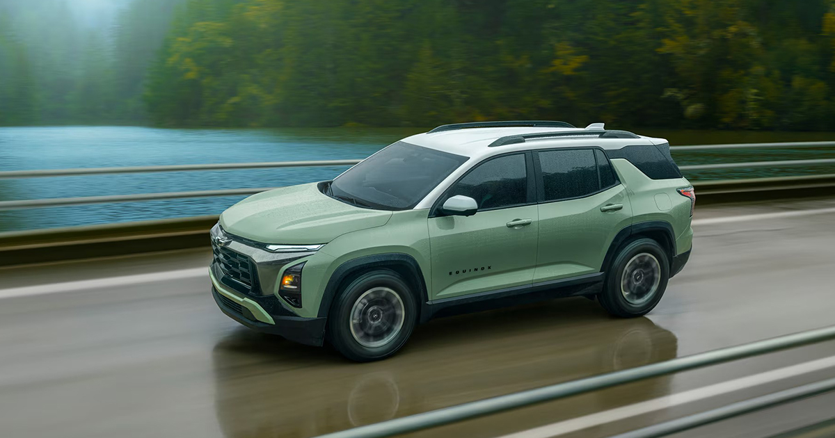 Image 2 - Green Equinox Activ Motion: "Light green 2026 Chevrolet Equinox Activ driving on wet road with motion blur, showcasing crossover dynamics
