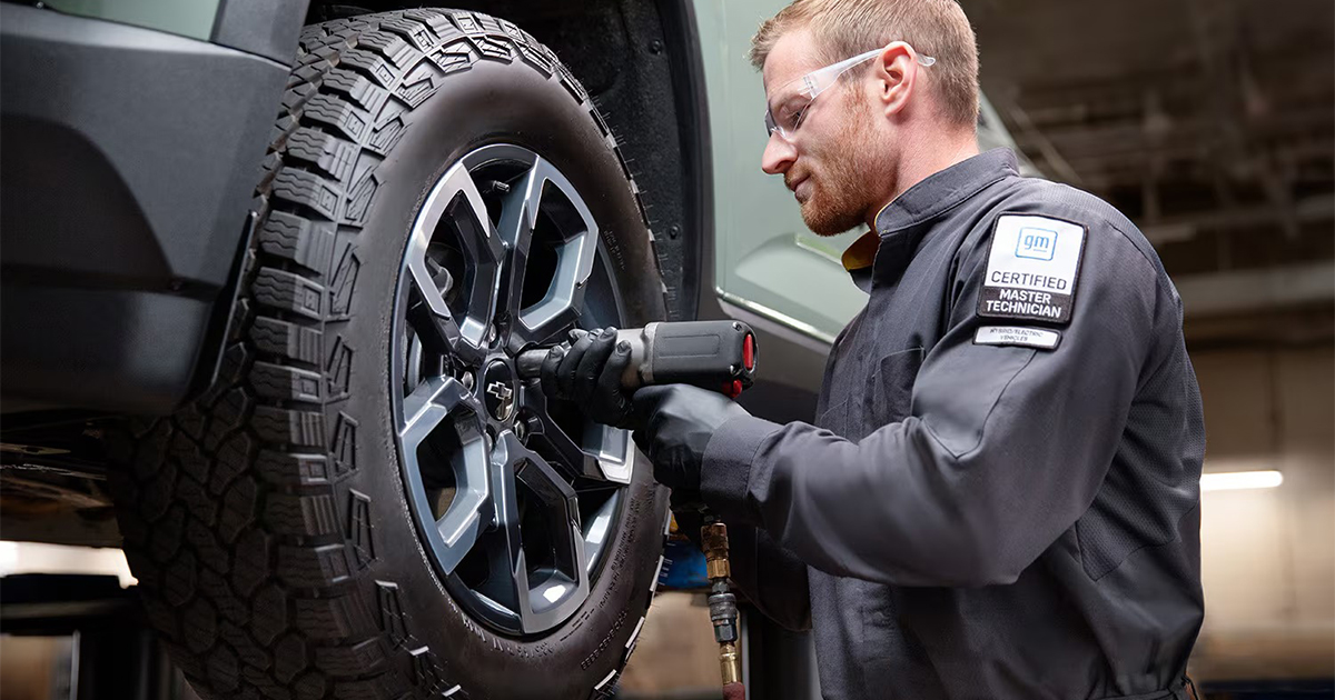 Chevrolet Certified Master Technician working on tire installation for vehicle with all-terrain tires